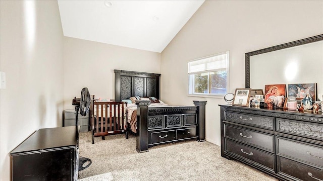 bedroom with light colored carpet and lofted ceiling