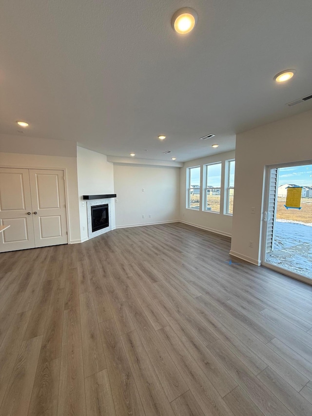 unfurnished living room with light hardwood / wood-style flooring