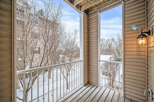 view of snow covered back of property