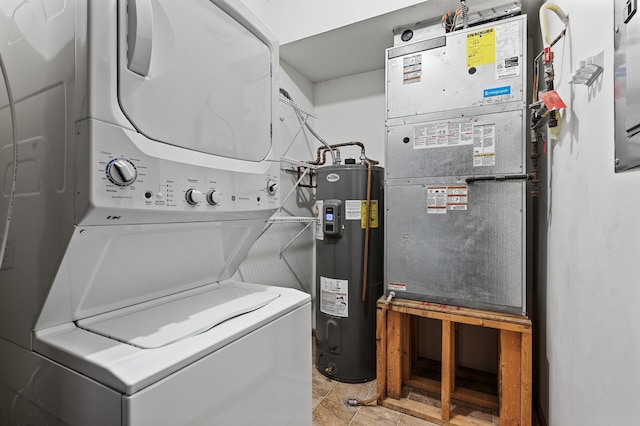 laundry room featuring stacked washer and dryer and electric water heater