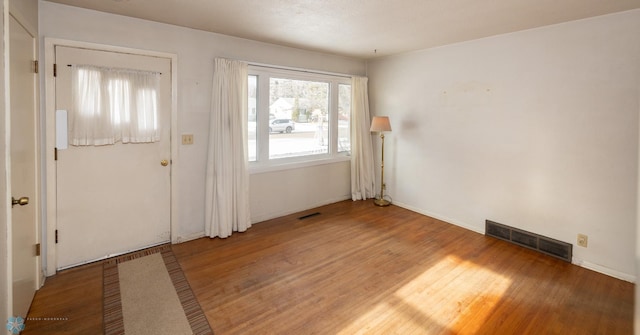 entryway with hardwood / wood-style floors