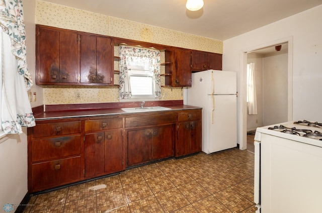 kitchen featuring sink and white appliances