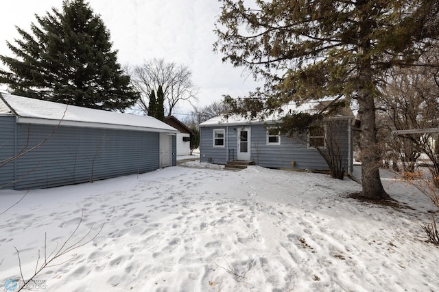 view of snow covered rear of property