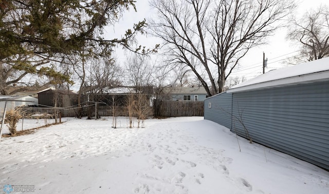 view of yard layered in snow