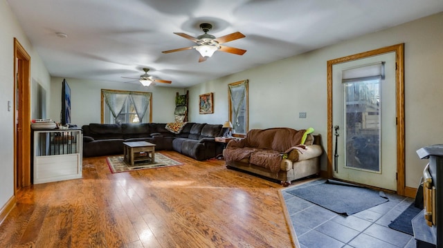 living room featuring wood-type flooring and ceiling fan