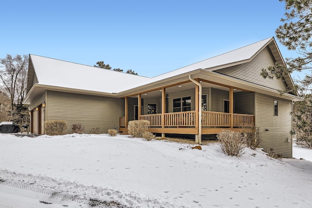 view of front facade featuring a porch and a garage