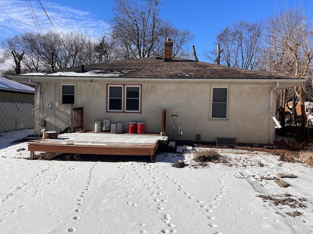 snow covered back of property featuring a wooden deck