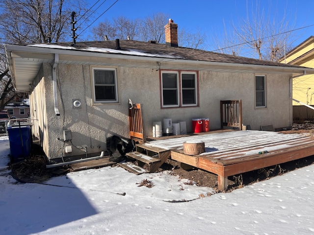 snow covered property featuring a deck