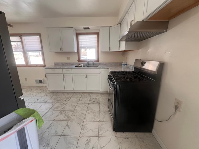 kitchen featuring white cabinetry, appliances with stainless steel finishes, range hood, and sink