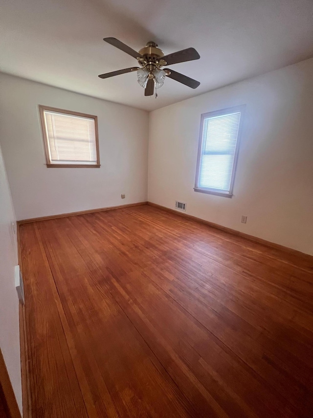 empty room featuring ceiling fan and wood-type flooring