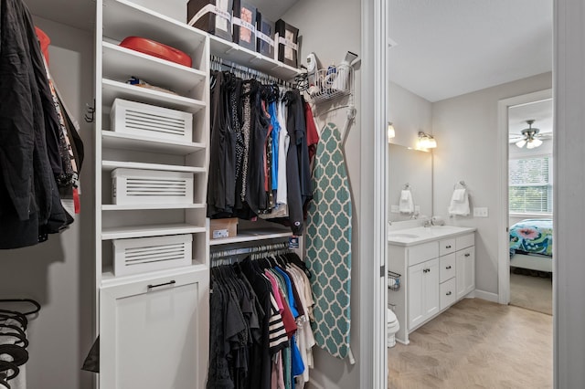 walk in closet with ceiling fan and sink