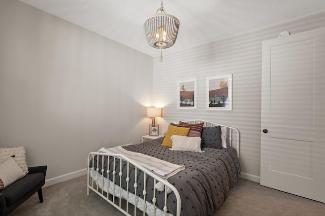 bedroom with a notable chandelier and carpet flooring