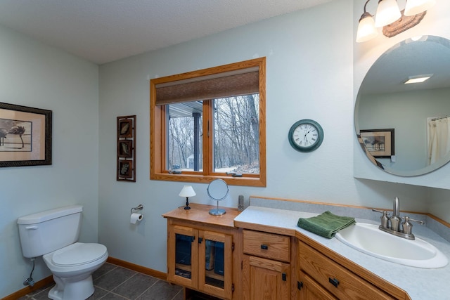 bathroom with vanity, toilet, tile patterned flooring, and a textured ceiling