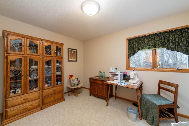 carpeted home office with a textured ceiling