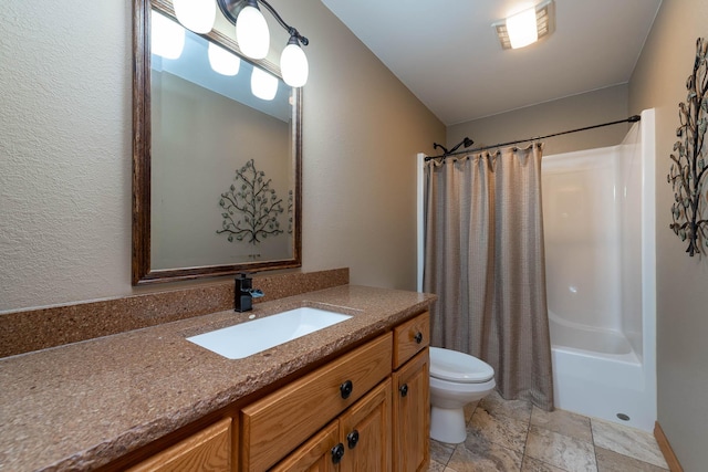 full bathroom with vanity, shower / tub combo, and toilet