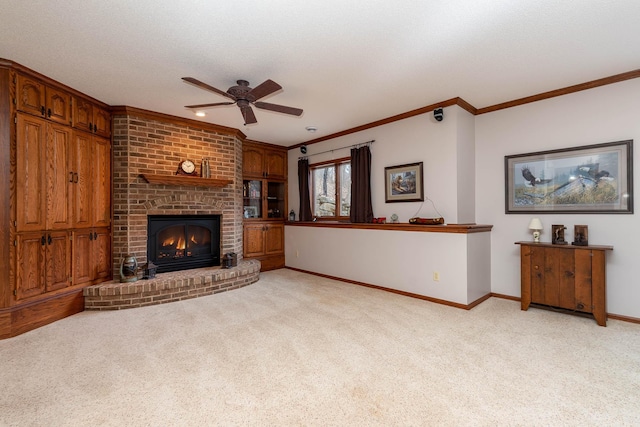 carpeted living room with crown molding, a fireplace, a textured ceiling, and ceiling fan