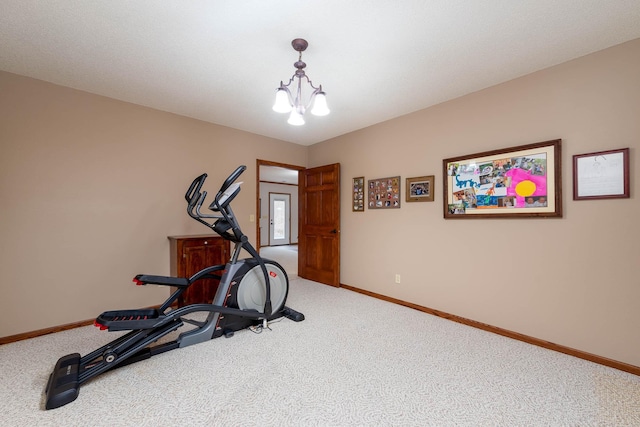 workout room featuring carpet floors and a chandelier