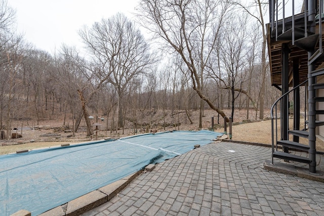 view of swimming pool featuring a patio area