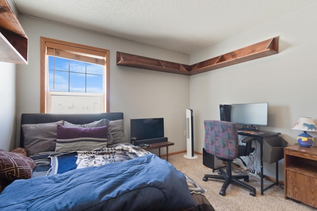 bedroom with carpet floors and a textured ceiling