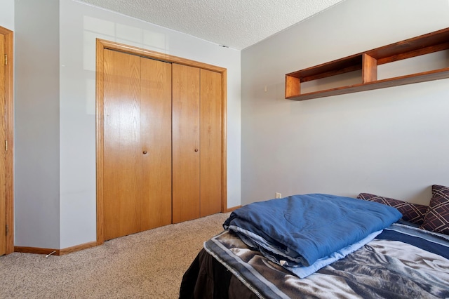 carpeted bedroom featuring a closet and a textured ceiling