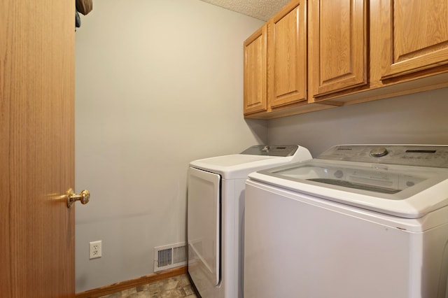 laundry area featuring cabinets and separate washer and dryer