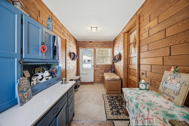 interior space featuring light carpet and wood walls