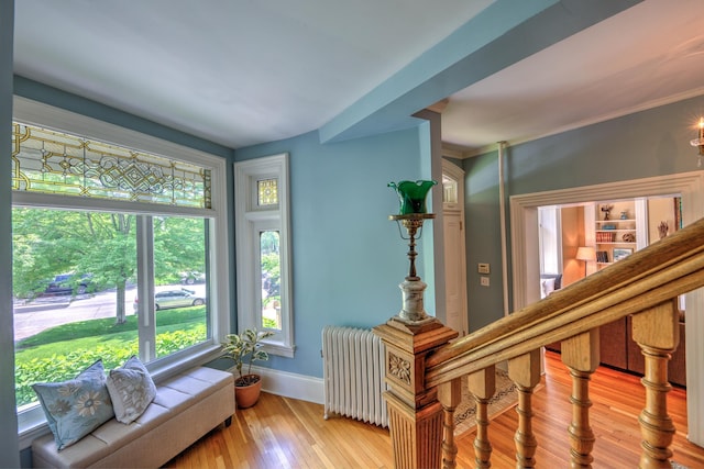 interior space with radiator and hardwood / wood-style floors