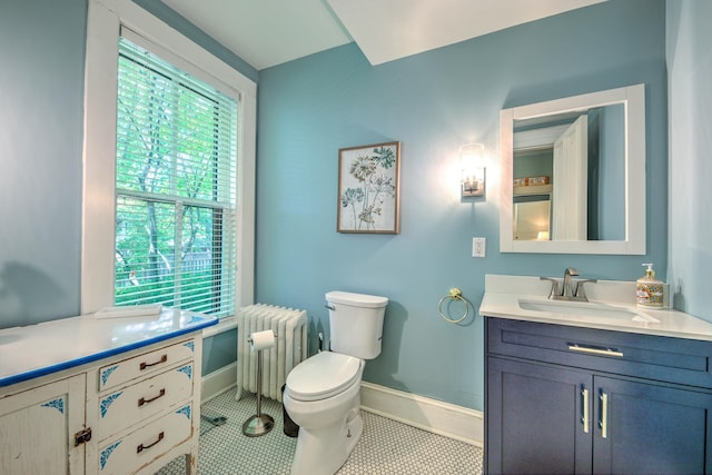 bathroom with vanity, radiator heating unit, tile patterned floors, and toilet