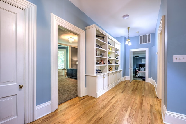 hall with light wood-type flooring