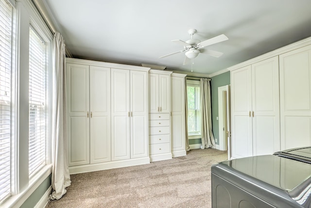 carpeted bedroom with washer / clothes dryer, crown molding, and ceiling fan