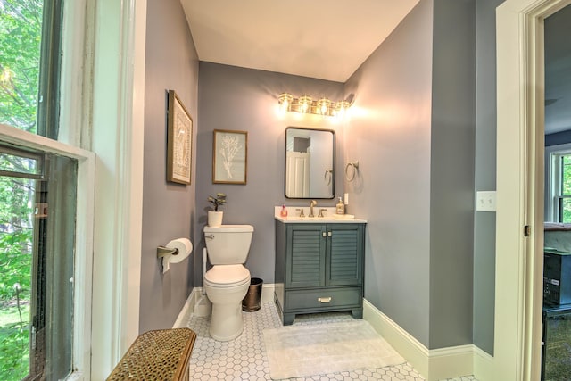 bathroom featuring vanity, toilet, and tile patterned flooring