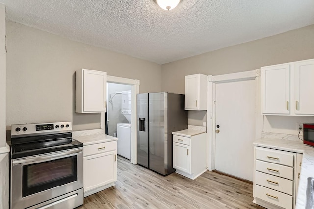 kitchen with a textured ceiling, stainless steel appliances, light hardwood / wood-style floors, and white cabinets