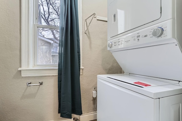 clothes washing area with stacked washer / drying machine