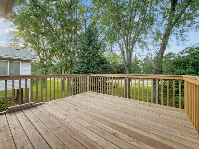 wooden deck featuring a yard