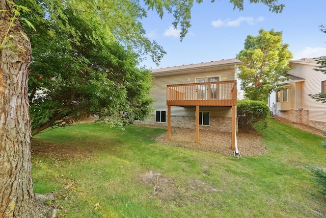 back of house featuring a yard and a deck