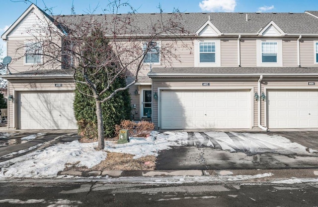 townhome / multi-family property featuring a garage