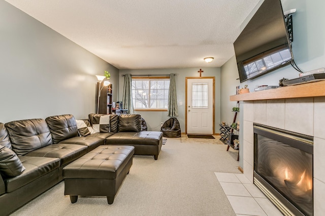 living room with light carpet, a fireplace, and a textured ceiling