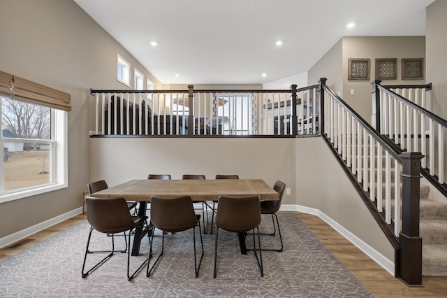 dining space featuring recessed lighting, visible vents, wood finished floors, baseboards, and stairs