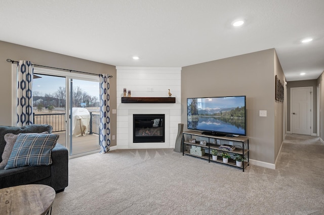 living room with recessed lighting, carpet flooring, a fireplace, and baseboards