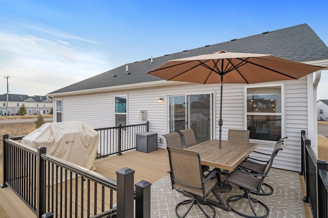 deck with outdoor dining area and grilling area