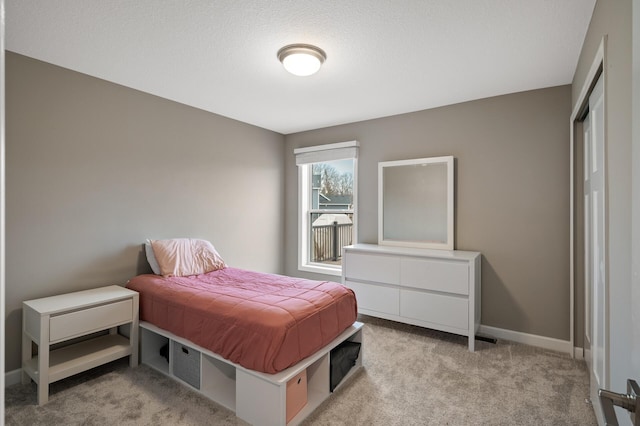 bedroom featuring baseboards and light colored carpet