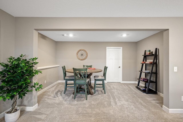 carpeted dining room featuring baseboards and recessed lighting