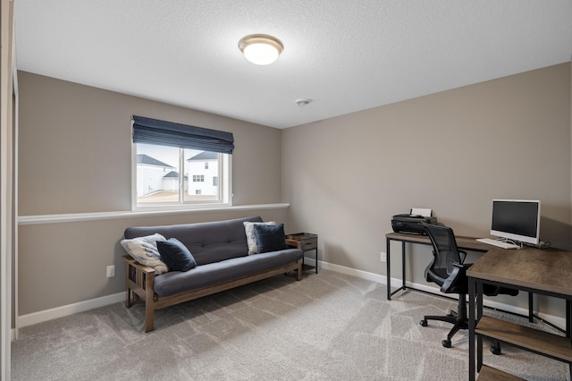 home office with a textured ceiling, carpet, and baseboards