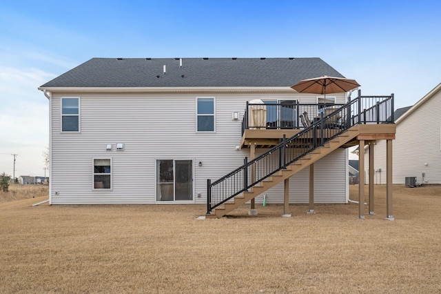 rear view of property featuring central AC unit, a wooden deck, stairway, and roof with shingles