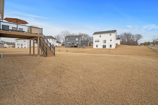 view of yard featuring stairs and a deck