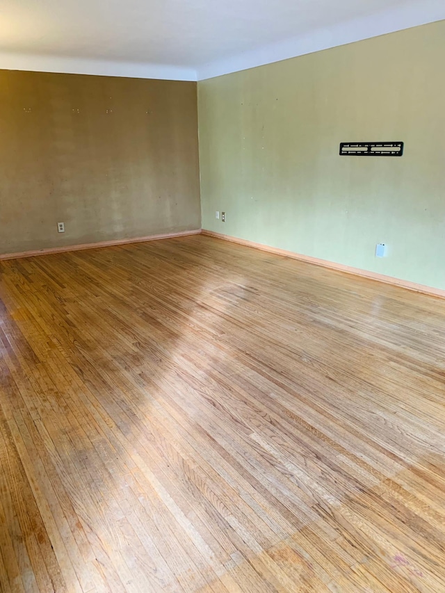 empty room with light hardwood / wood-style flooring