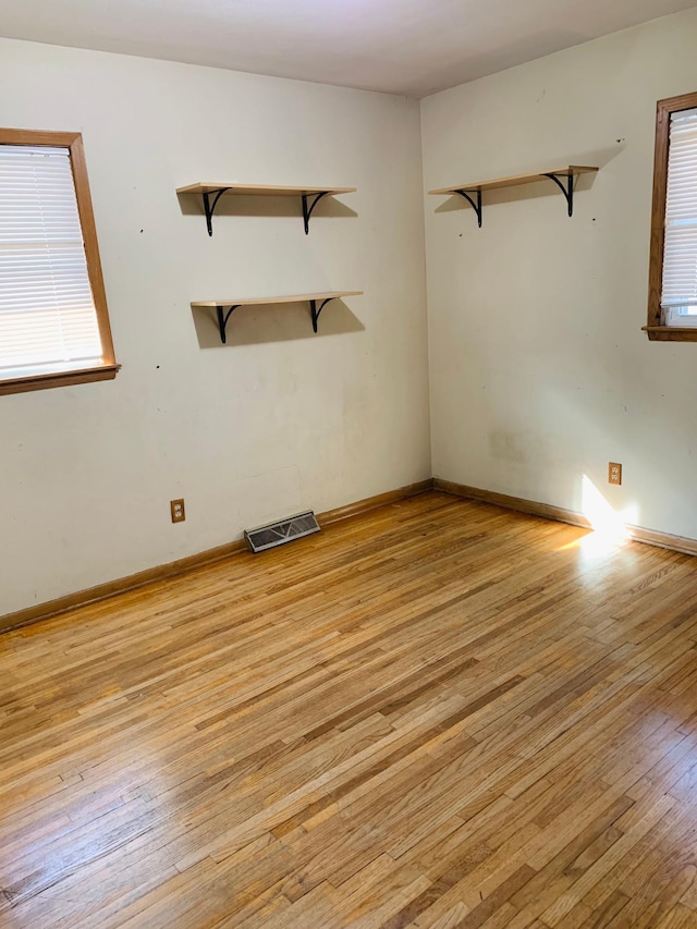 unfurnished room with light hardwood / wood-style flooring