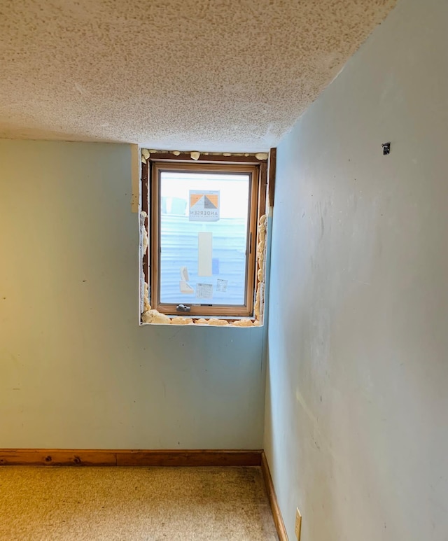 unfurnished room with a textured ceiling