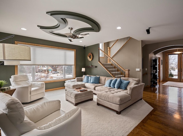 living room featuring wood-type flooring and ceiling fan