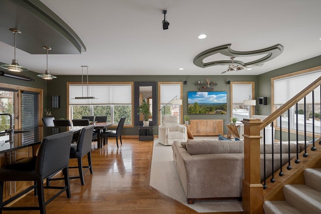 living room with ceiling fan and hardwood / wood-style floors